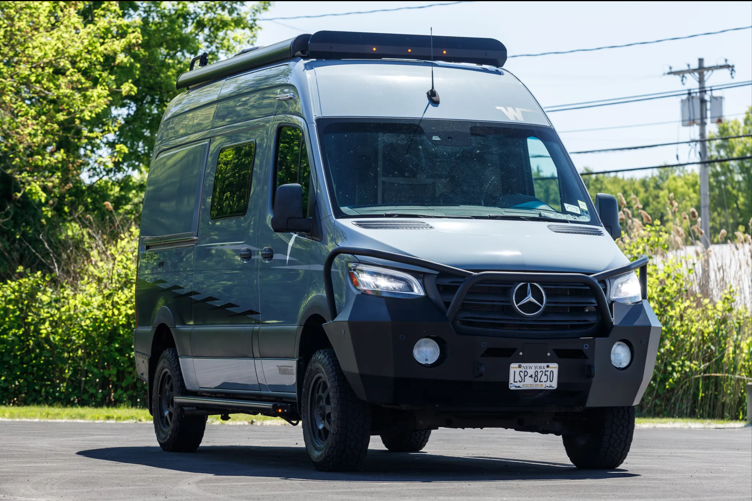 Front quarter view — headlights on, bull bar and off-road stance